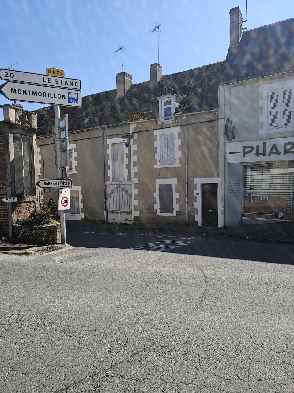 A village corner with road signs to Le Blanc and Montmorillon